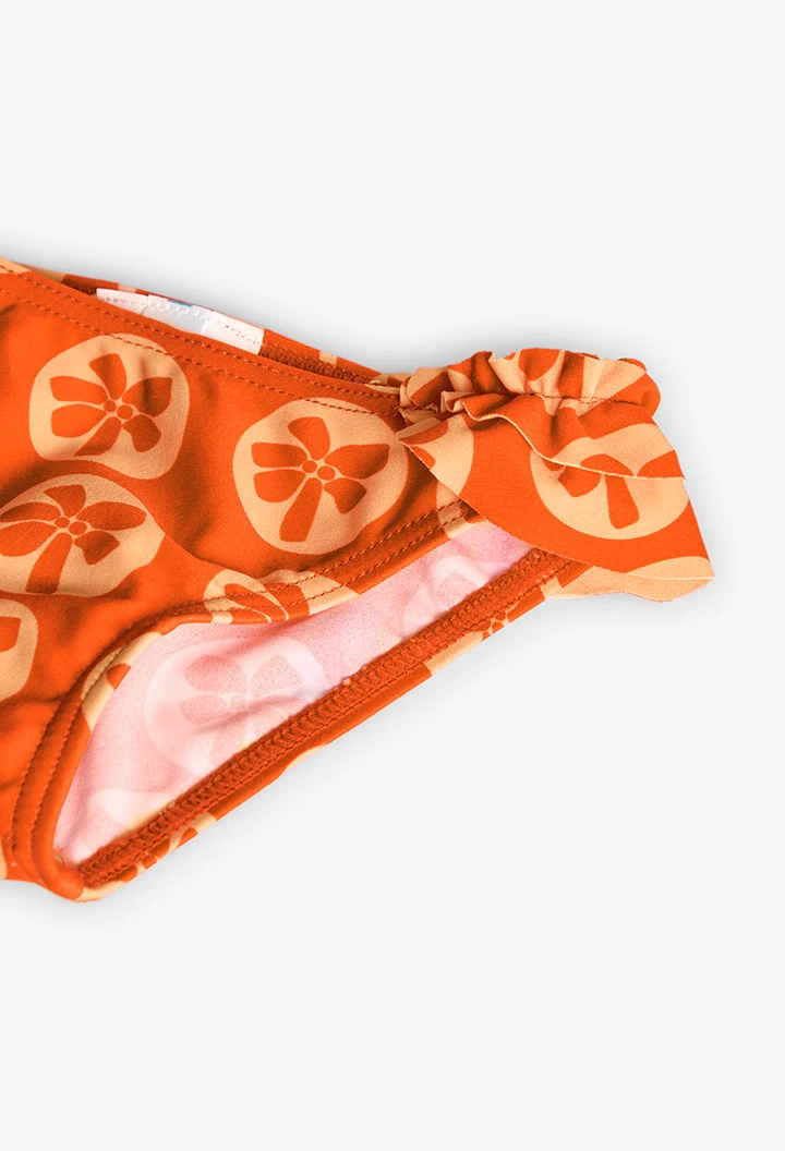 Cueca de banho de poliamida para bebé menina com estampado em cor laranja.