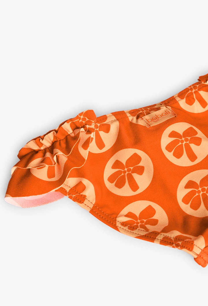 Cueca de banho de poliamida para bebé menina com estampado em cor laranja.