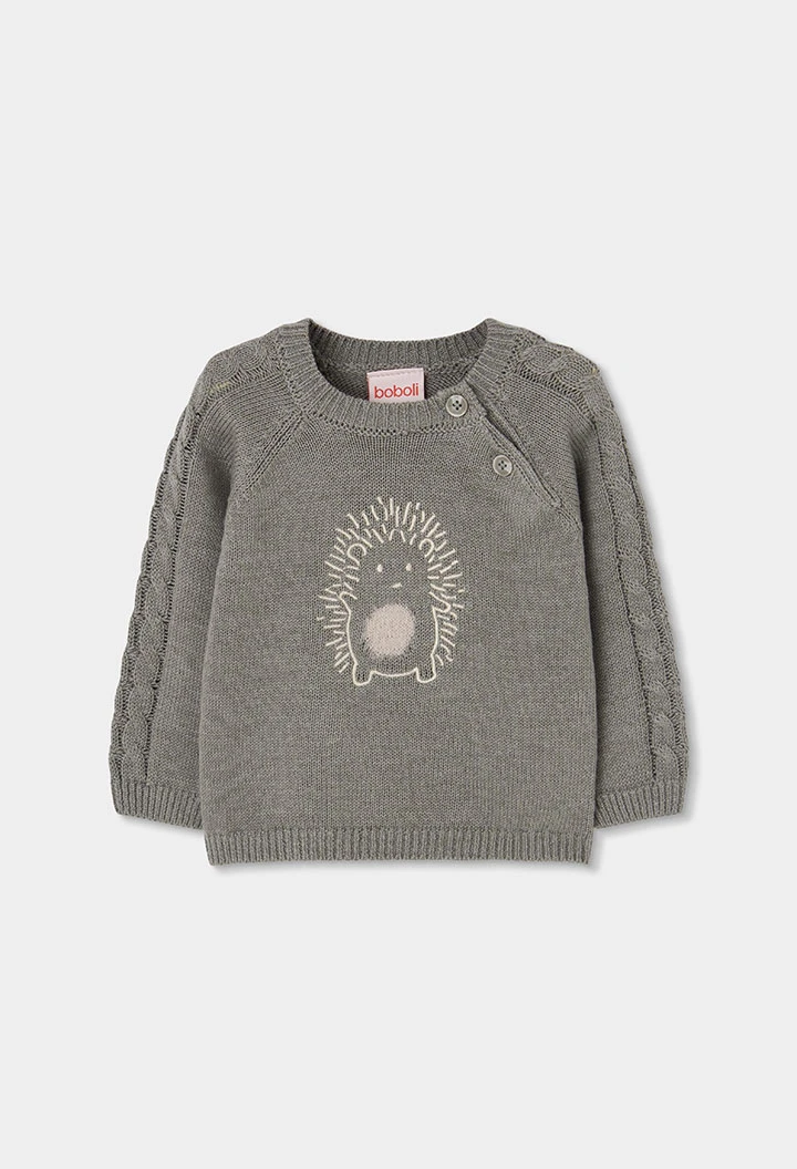 Grünes Strickpullover für Baby mit Igel-Stickerei