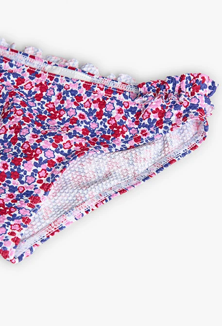 Polyamide bikini for girls with a floral print in red and blue.