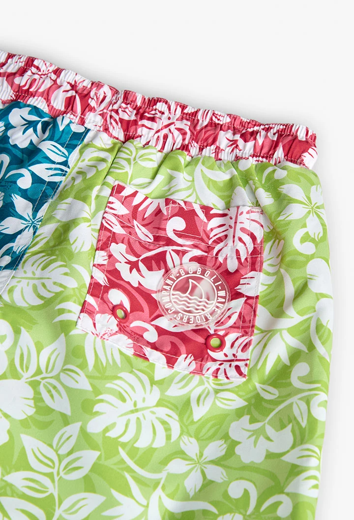 Boy\'s swimming trunks in recycled fabric, green with floral design.